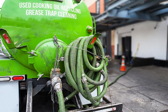 worker pumping grease trap at commercial kitchen in Bannockburn IL