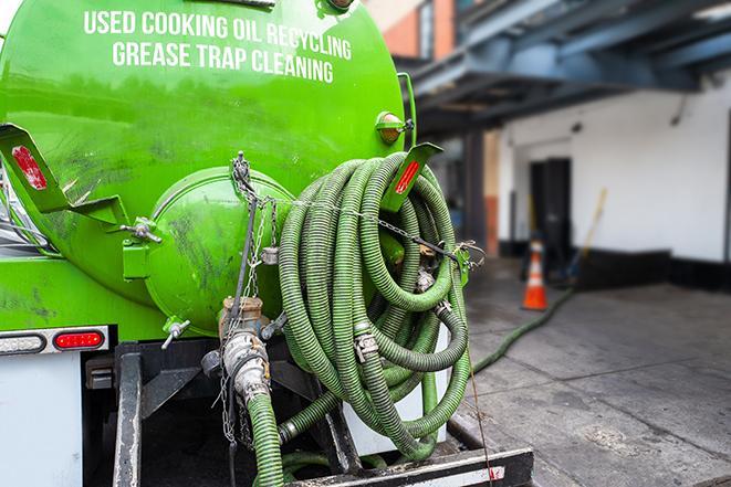 septic tank pump truck in operation in Hainesville